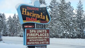 A sign for Tahoe Hacienda Inn, indicating it has spa units, fireplaces, 2 bedroom family units with kitchenette, heated pool, and hot tub. - Tahoe Hacienda Inn (South Lake Tahoe)