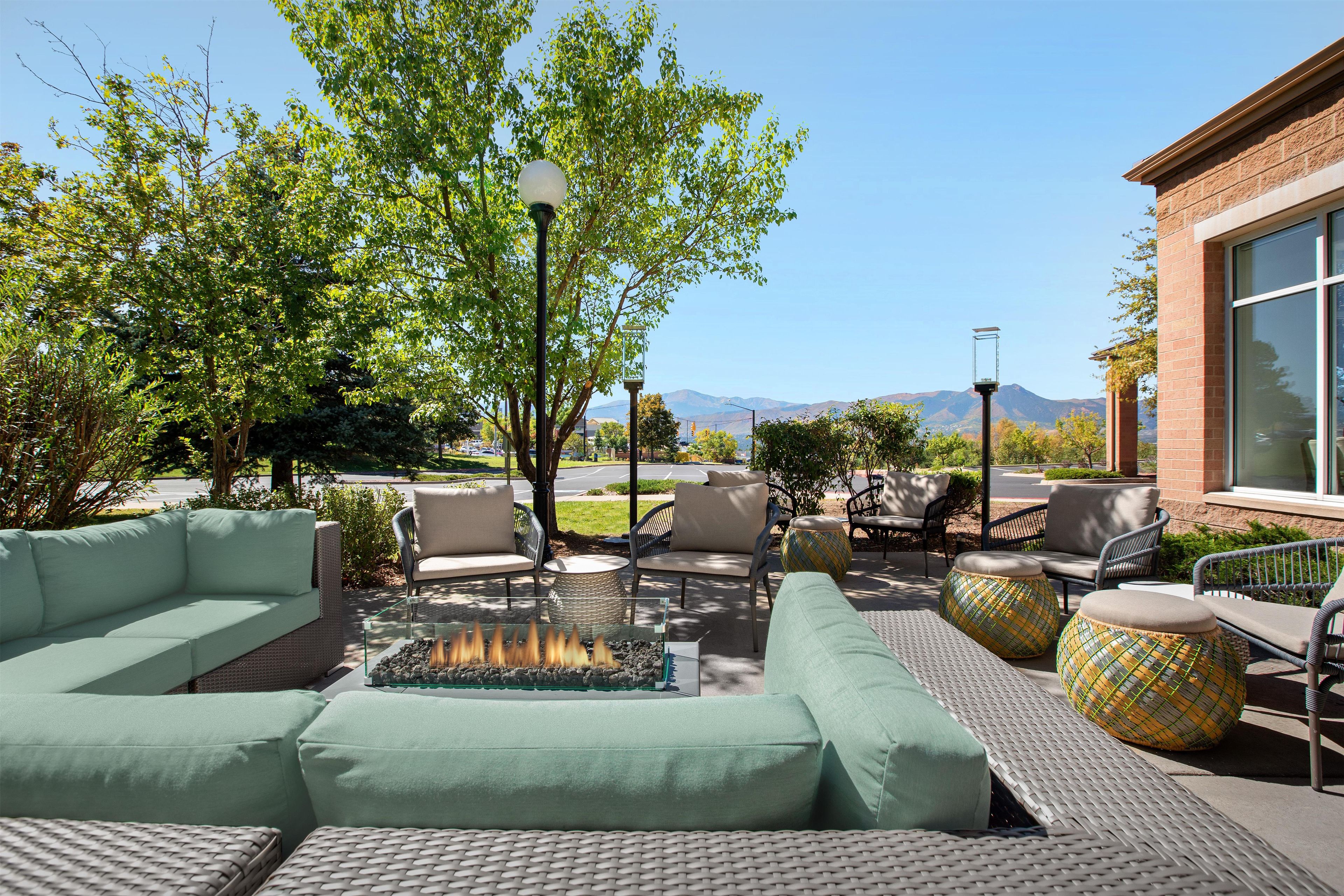 An outdoor seating area with sofas, chairs, and a fire feature.