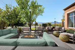 An outdoor seating area with sofas, chairs, and a fire feature. - Hilton Garden Inn Colorado Springs North Air Force Academy (Colorado Springs)