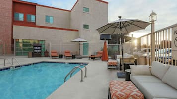 Seasonal outdoor pool, open 8 AM to 10 PM, pool umbrellas, pool loungers