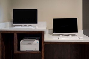 Two desktop computers on a white desk with a printer below. - Baymont by Wyndham Henderson Northeast Denver (Henderson)