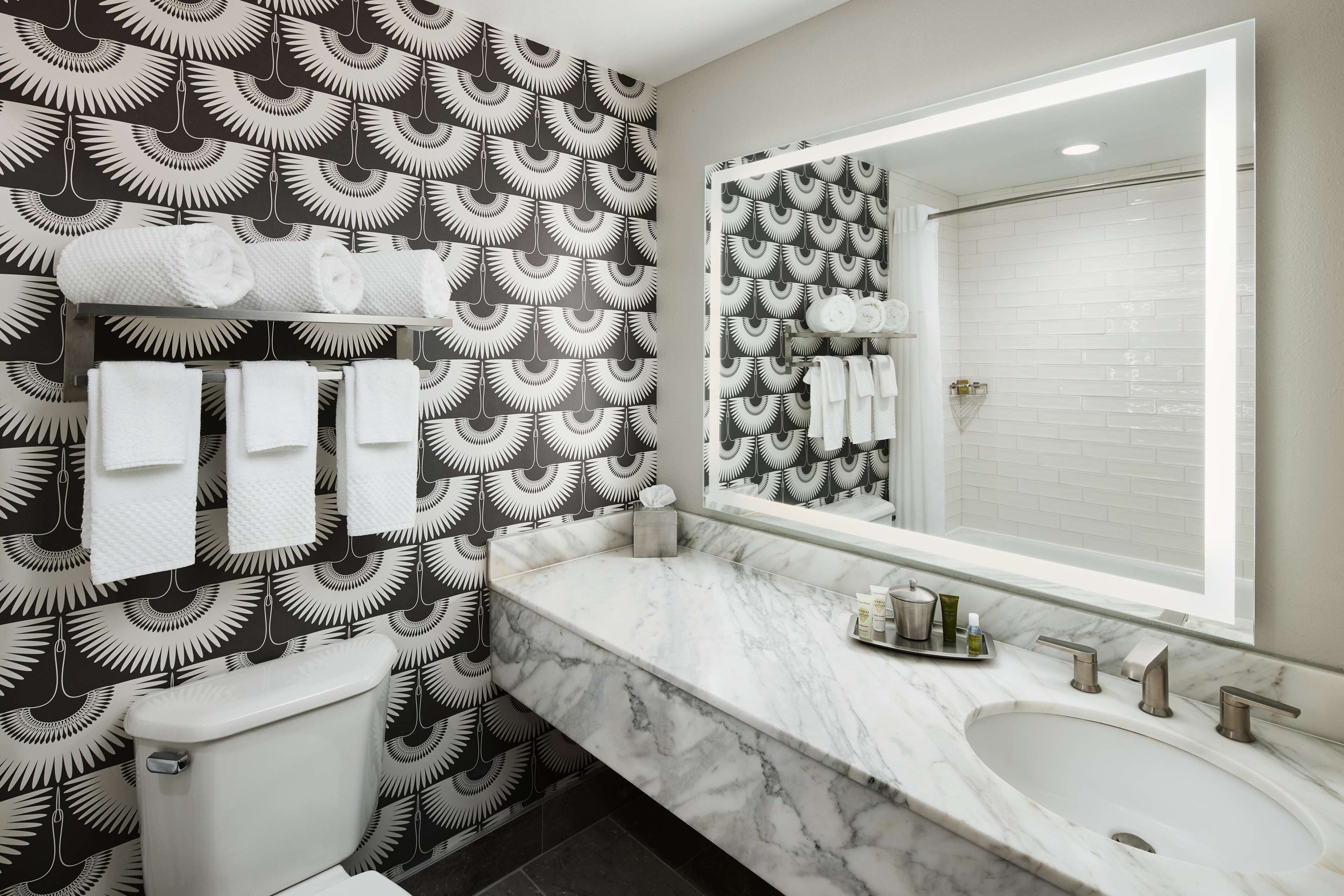 combined shower/bathtub, designer toiletries, hair dryer, towels