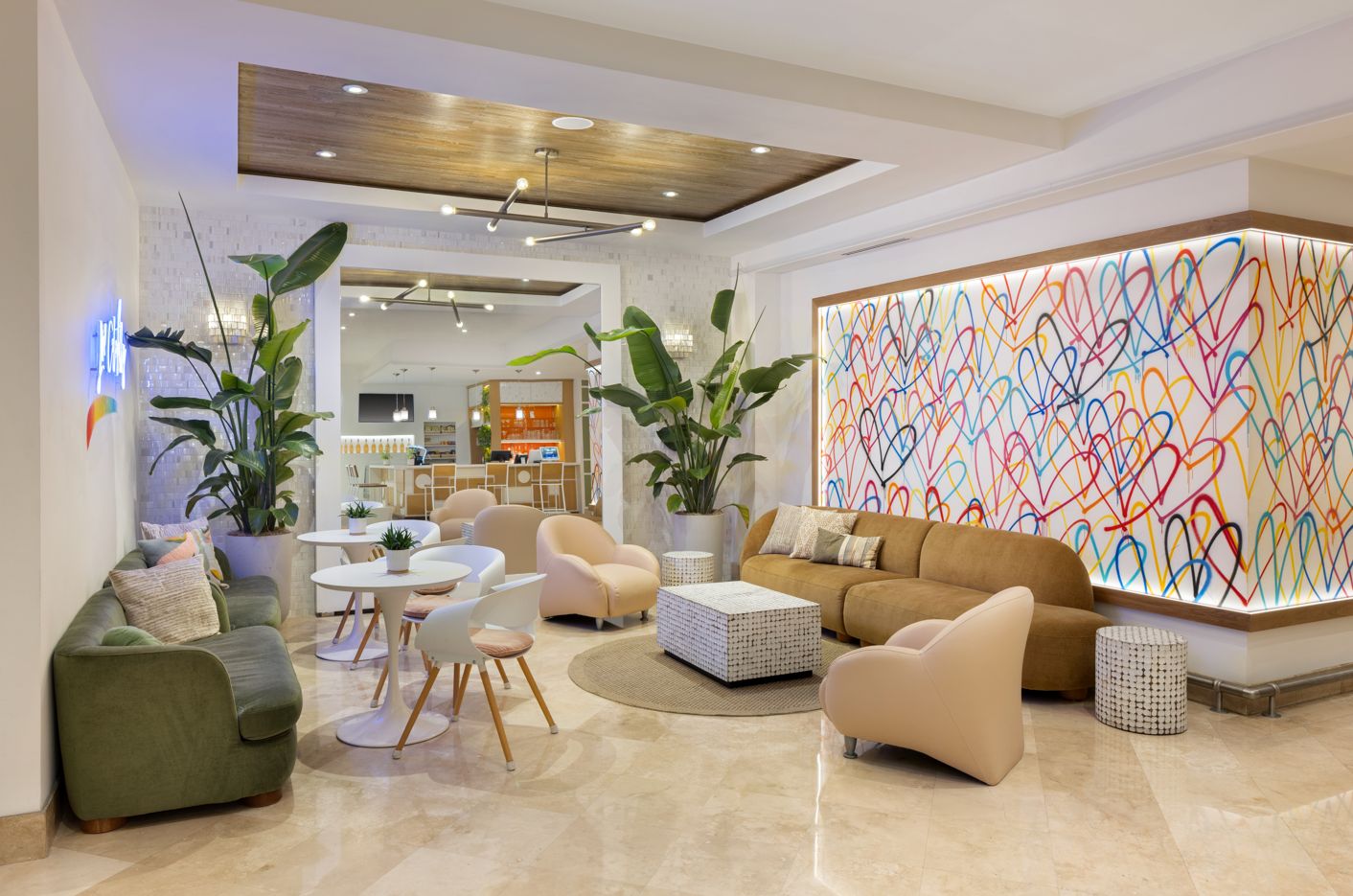 A modern living room with a sofa, chairs, a coffee table, and a colorful abstract wall art.