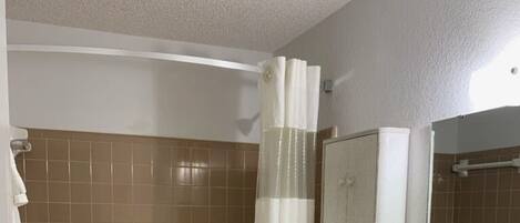 A bathroom with a bathtub, toilet, and sink.