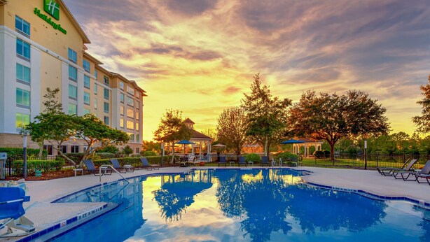 A hotel pool area with a clear view of the pool, lounge chairs, and a gazebo. - Holiday Inn St. Augustine - World Golf by IHG (St. Augustine)