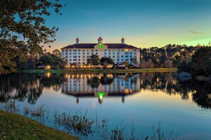 A large hotel with a symmetrical facade, a central tower, and a reflection in the water. - Holiday Inn St. Augustine - World Golf by IHG (St. Augustine)