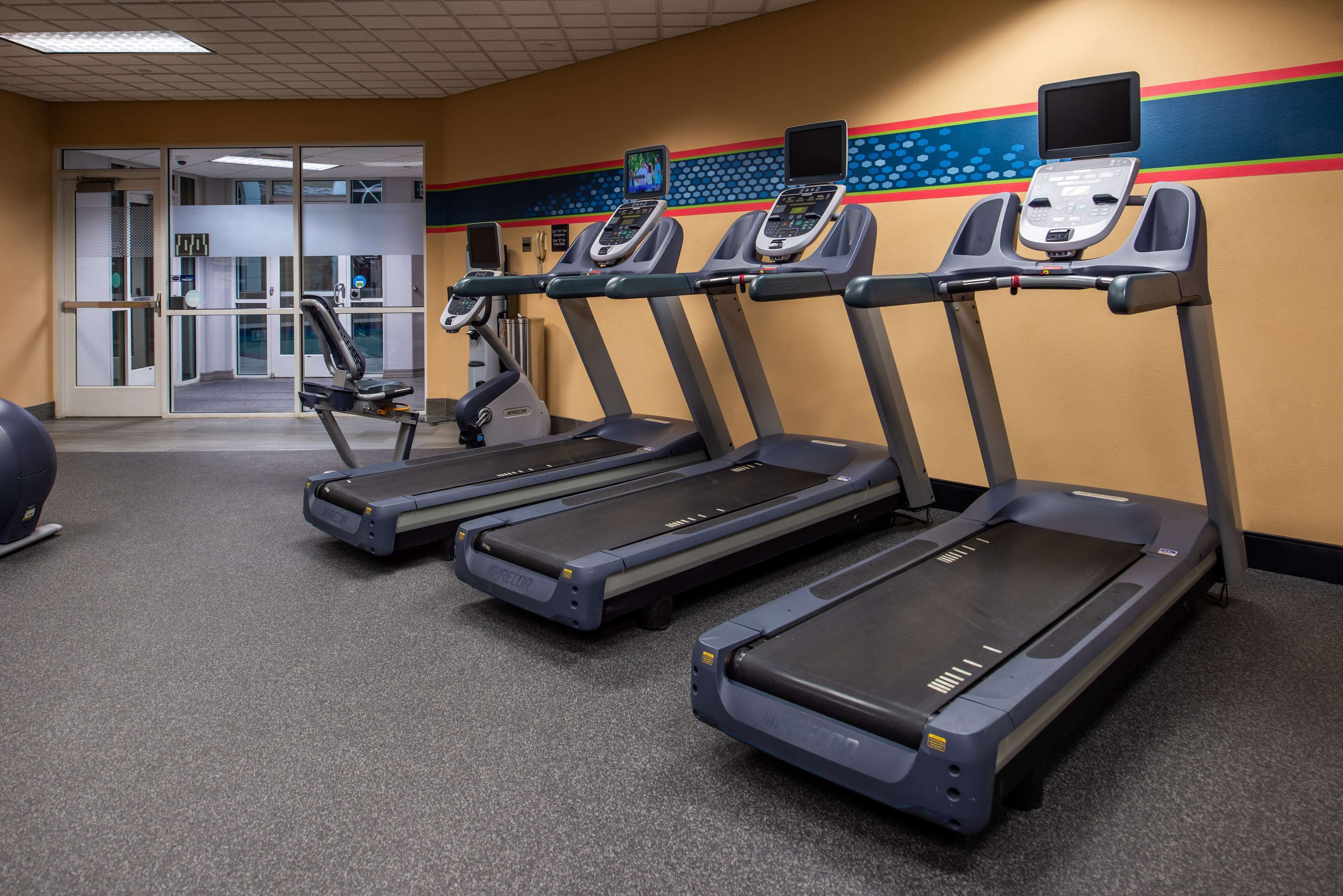 A gym with treadmills, a stationary bike, and a weight machine.