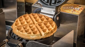 A waffle maker with a waffle inside.