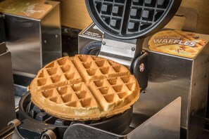 A waffle maker with a waffle inside.
