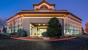 A multi-story hotel with a prominent entrance, large windows, and a well-lit facade. - Hampton Inn & Suites Boise/Spectrum (Boise)