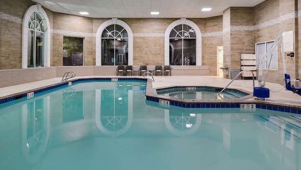 An indoor swimming pool with clear water, a hot tub, and a seating area with chairs. - Hampton Inn & Suites Boise/Spectrum (Boise)