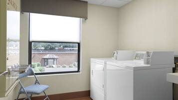 A laundry room with a folding chair, a washer, and a dryer.