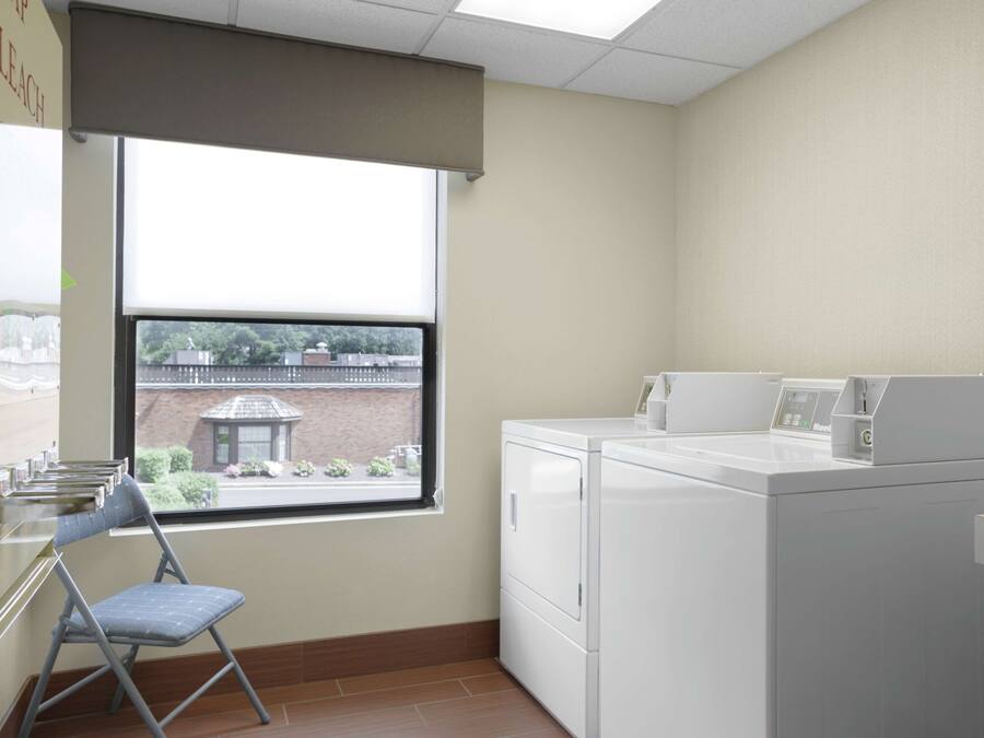 A laundry room with a folding chair, a washer, and a dryer.