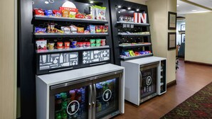A vending area with snacks, drinks, and a 'TREAT' sign. - Hampton Inn Jasper (Jasper)