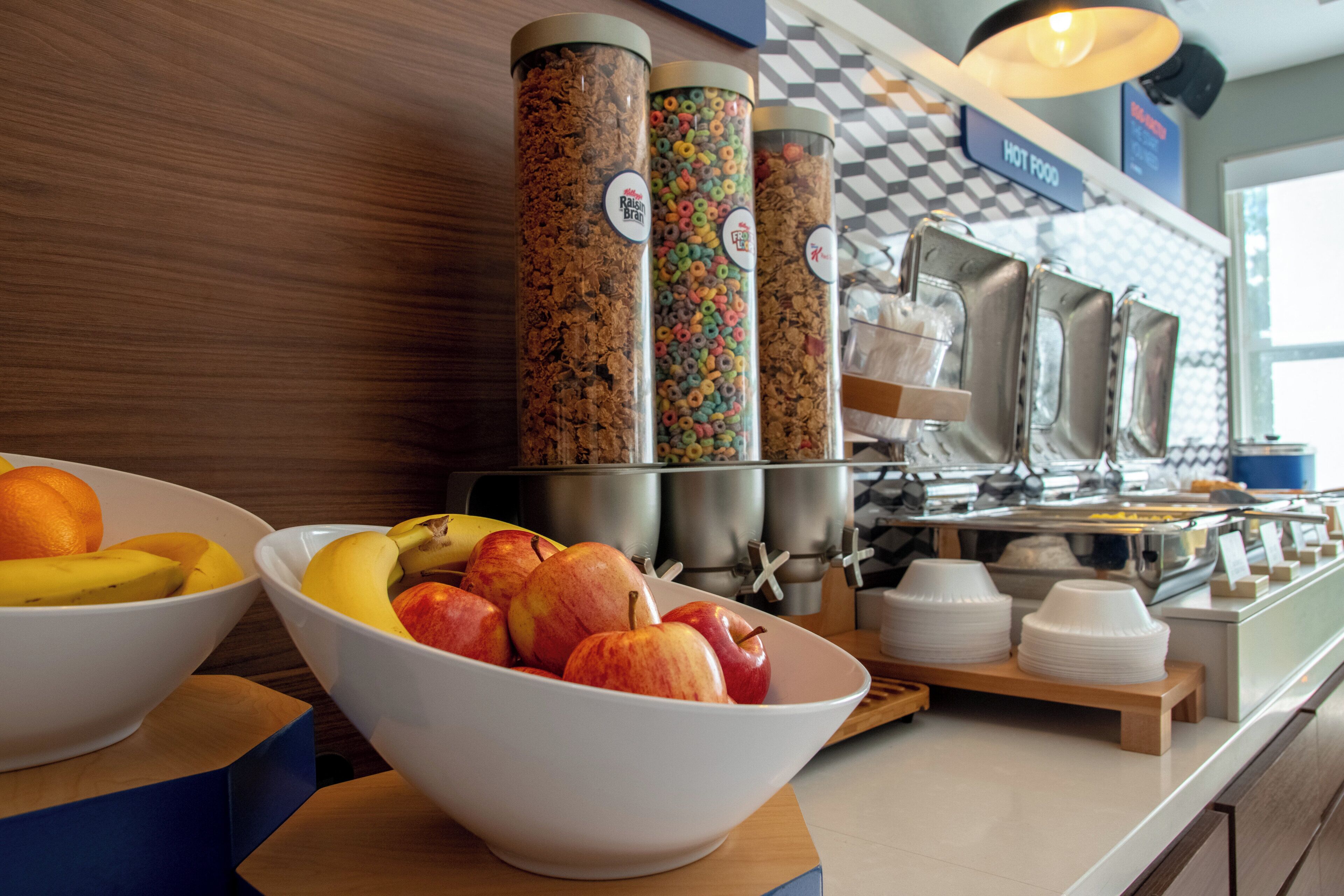 A breakfast buffet with various food items and containers.