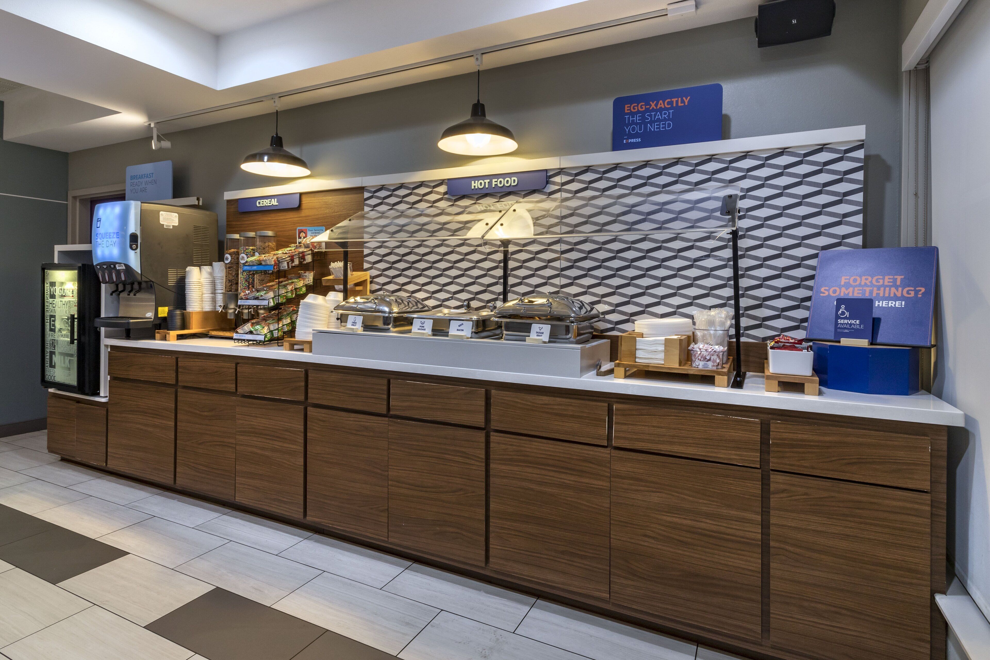 A modern food counter with labeled sections for breakfast, cereal, and hot food.
