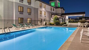 A hotel with a swimming pool, lounge chairs, and a covered outdoor seating area. - Wingate by Wyndham Salisbury MD Airport North (Salisbury)