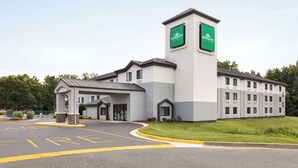 A Wingate Inn building with a modern design, featuring a prominent tower and a covered entrance.