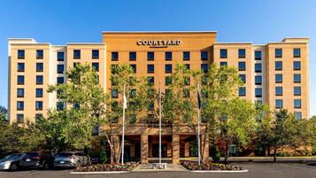 A Courtyard by Marriott hotel with a symmetrical facade, multiple floors, and a central entrance.