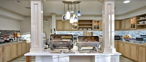 A modern kitchen with a central island, stainless steel appliances, and wooden cabinets.