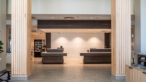 A reception area with two counters, a patterned wall, and a wooden floor.