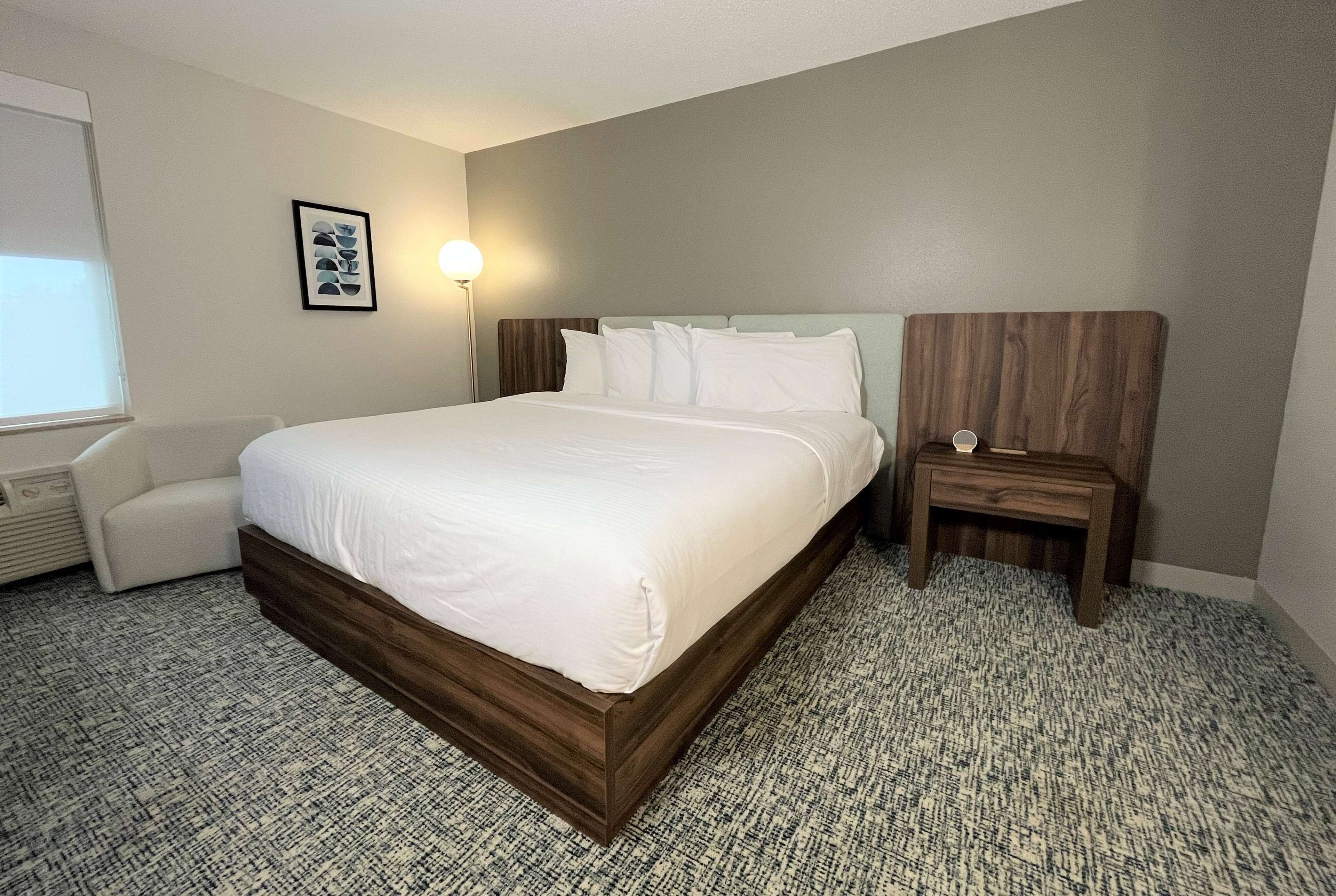 Premium bedding, desk, laptop workspace, blackout drapes