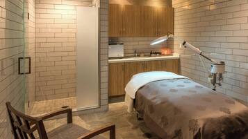Cozy retreat with a bed, kitchenette, and bench.