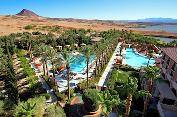 A restaurant with large arched windows, tables set for dining, and a view of the outdoors. at The Westin Lake Las Vegas Resort & Spa by Marriott
