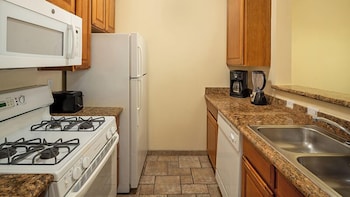 Microwave, coffee/tea maker, cookware/dishes/utensils at Club De Soleil All-Suite Resort