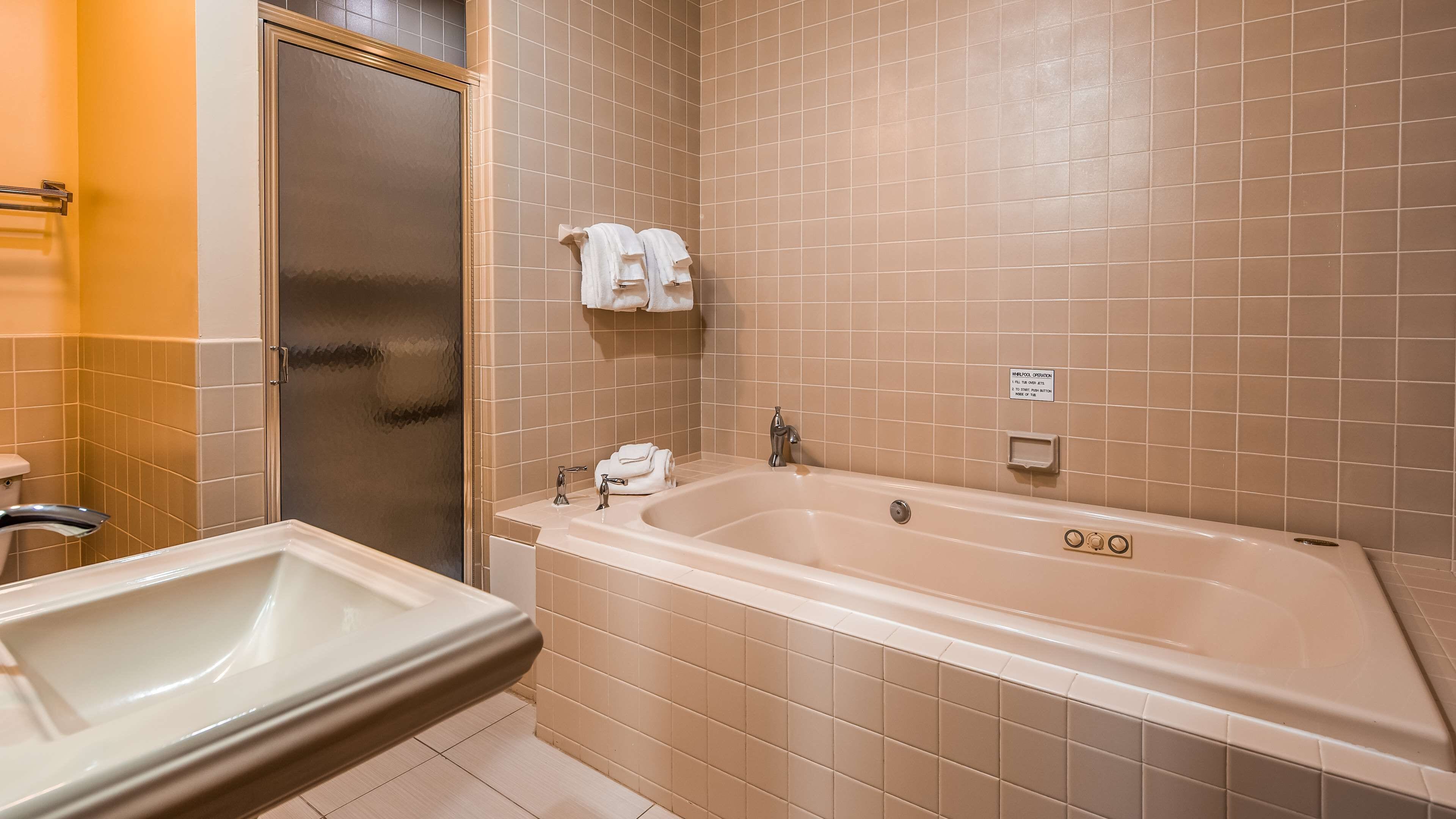 A bathroom with a bathtub, a sink, and a toilet.