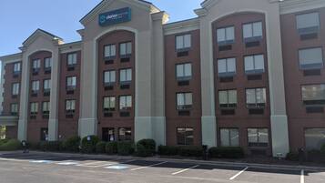 A Clarion Pointe hotel with a brick facade, multiple windows, and a sign indicating it is by Choice Hotels.