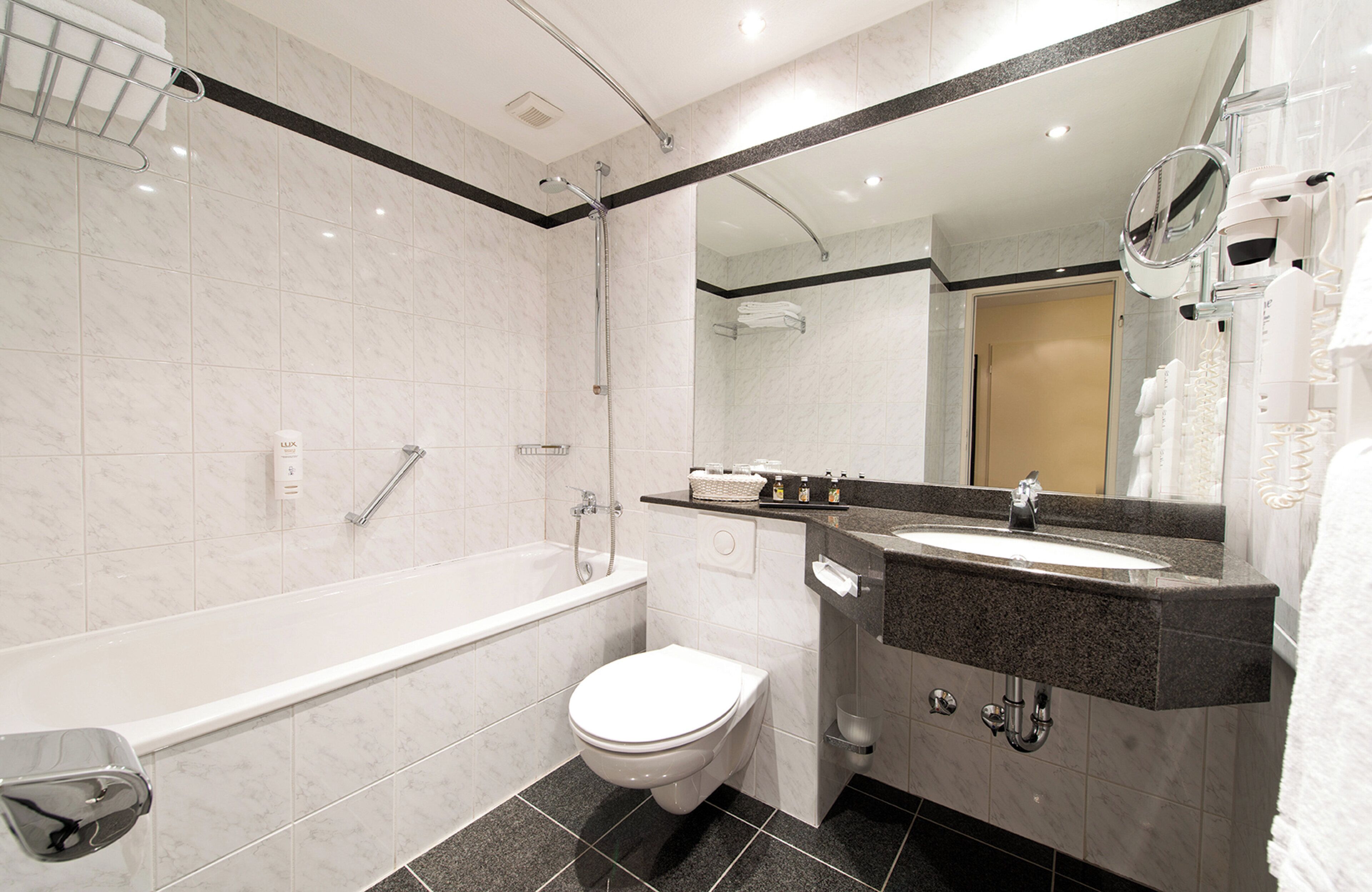 bathtub, free toiletries, hair dryer, towels