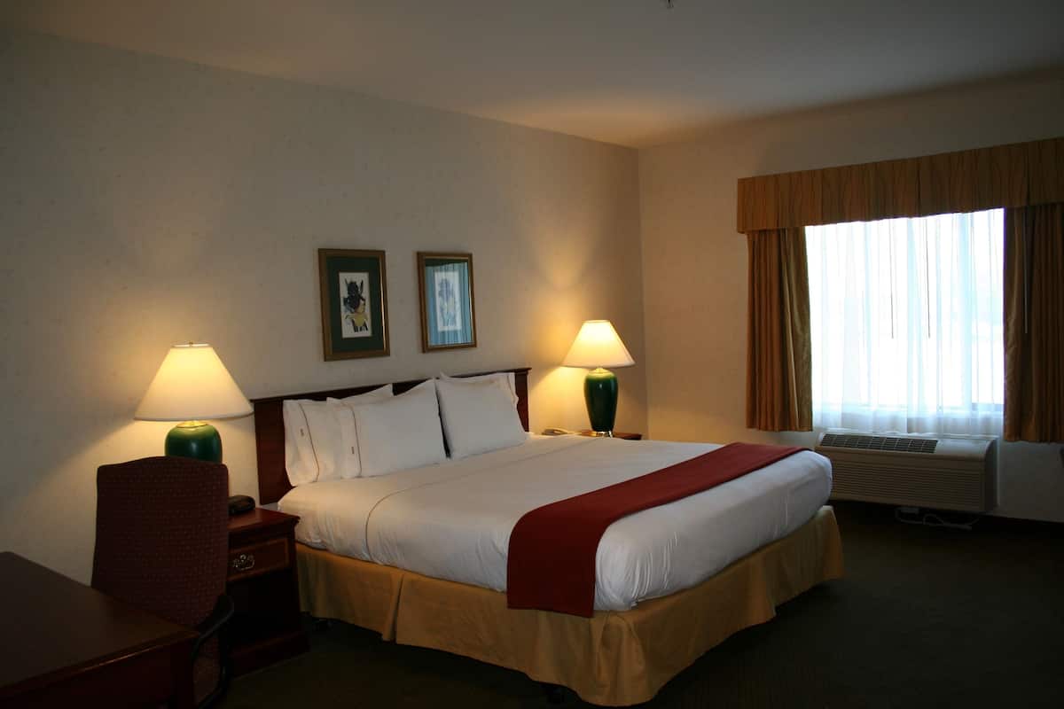Premium bedding, desk, laptop workspace, blackout drapes