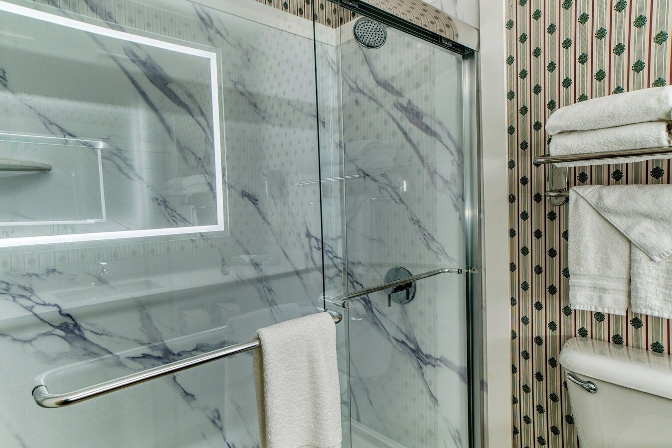 combined shower/bathtub, designer toiletries, hair dryer, towels