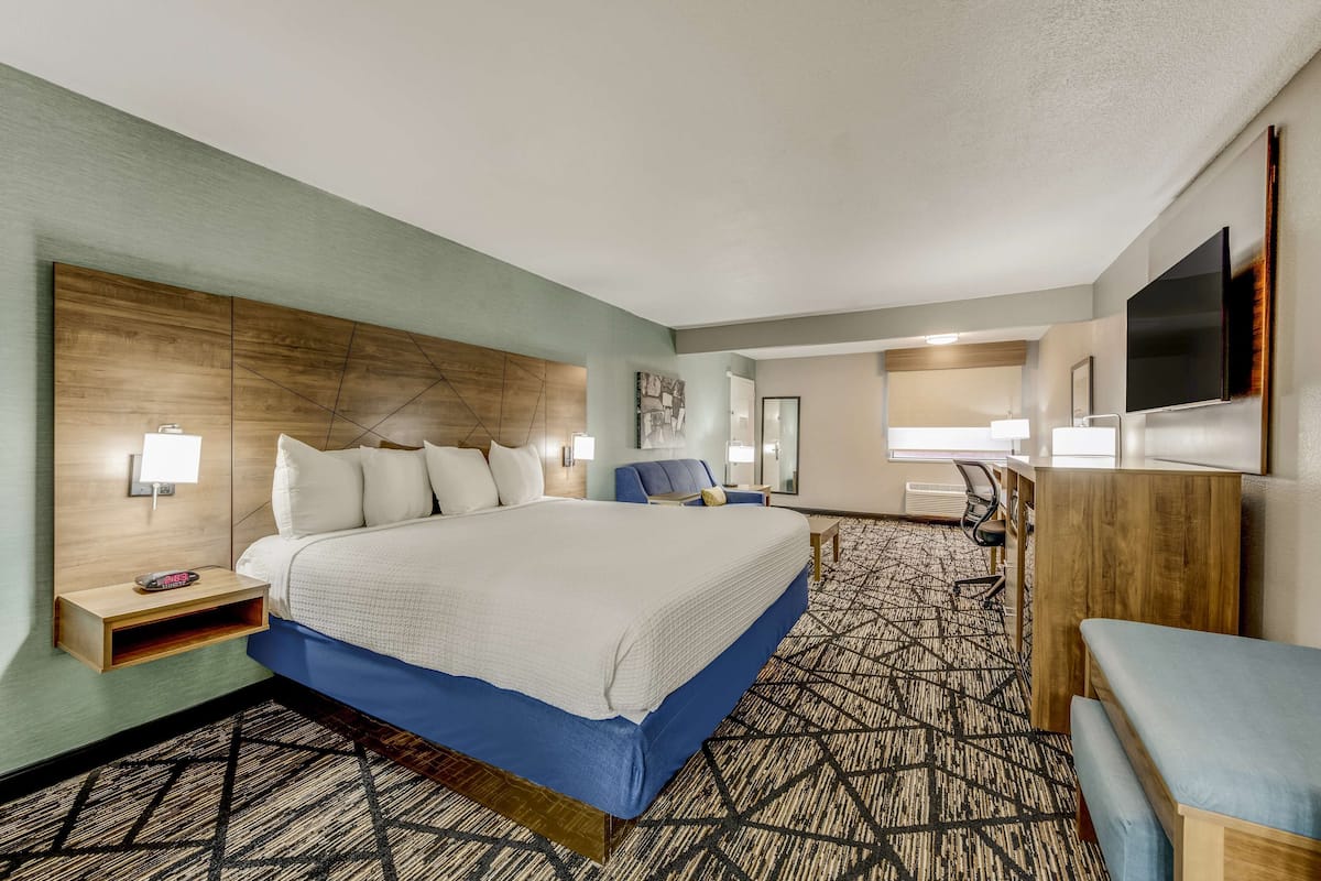 Premium bedding, desk, laptop workspace, iron/ironing board