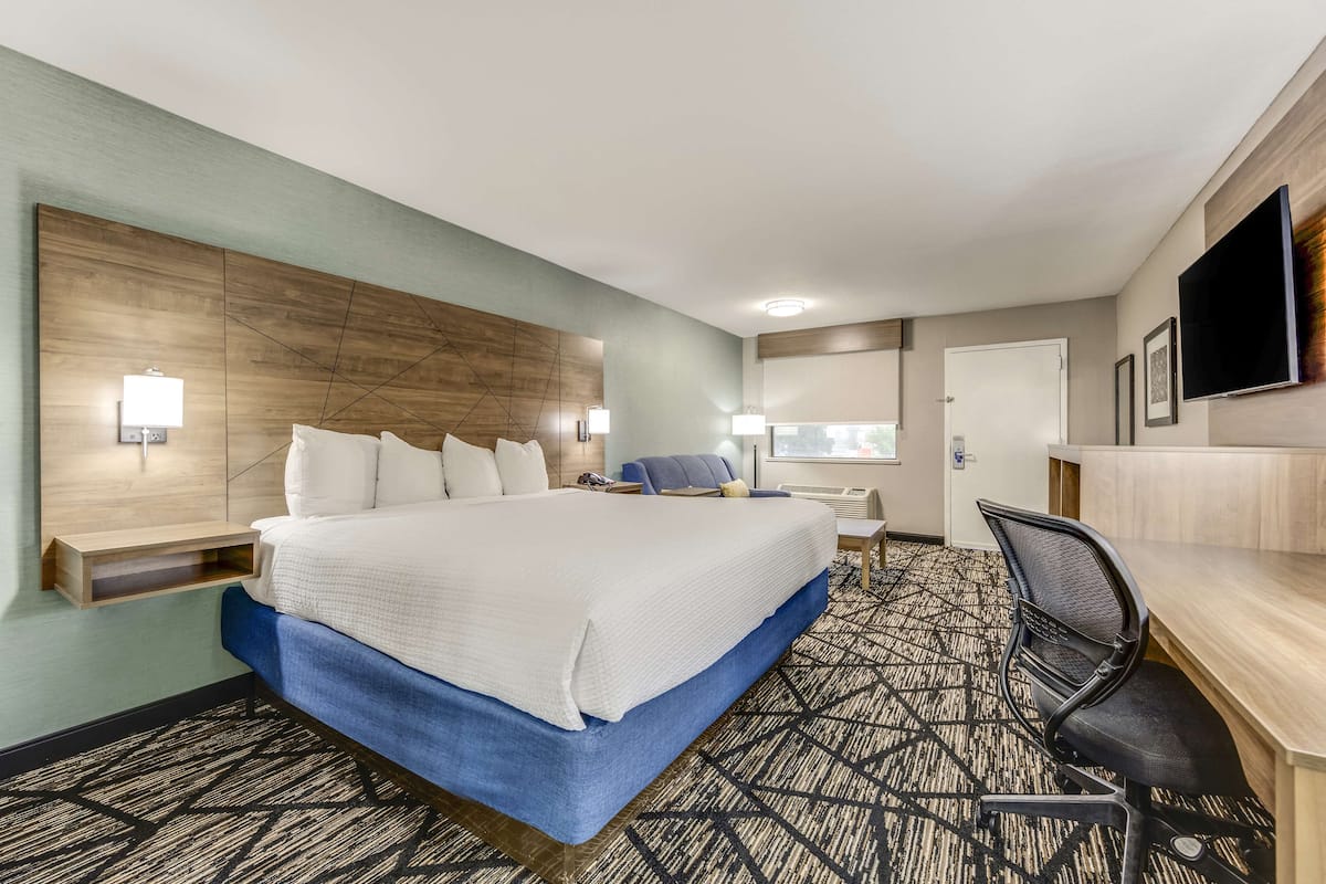 Premium bedding, desk, laptop workspace, iron/ironing board