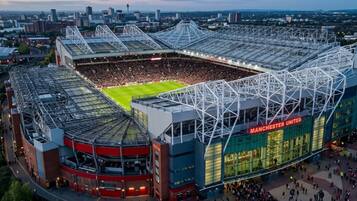 A stadium with a large central field surrounded by tiered seating.