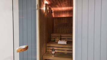 A sauna with wooden benches and a towel placed on one.