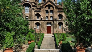 A historic building with a central entrance, arched windows, and a tower. - Hyatt Regency Thessaloniki (Thermi)