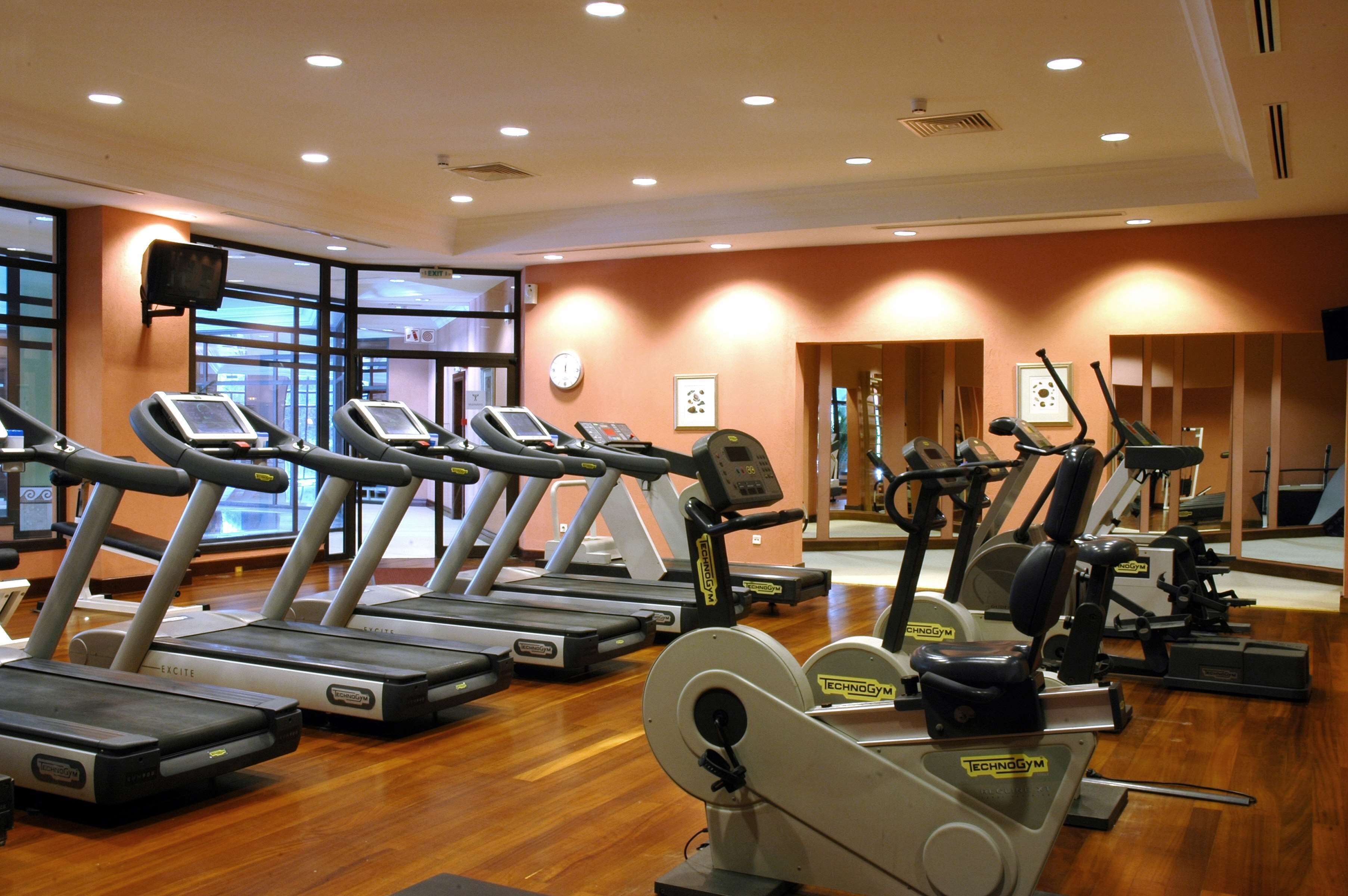 A gym with treadmills, stationary bikes, and weight machines.