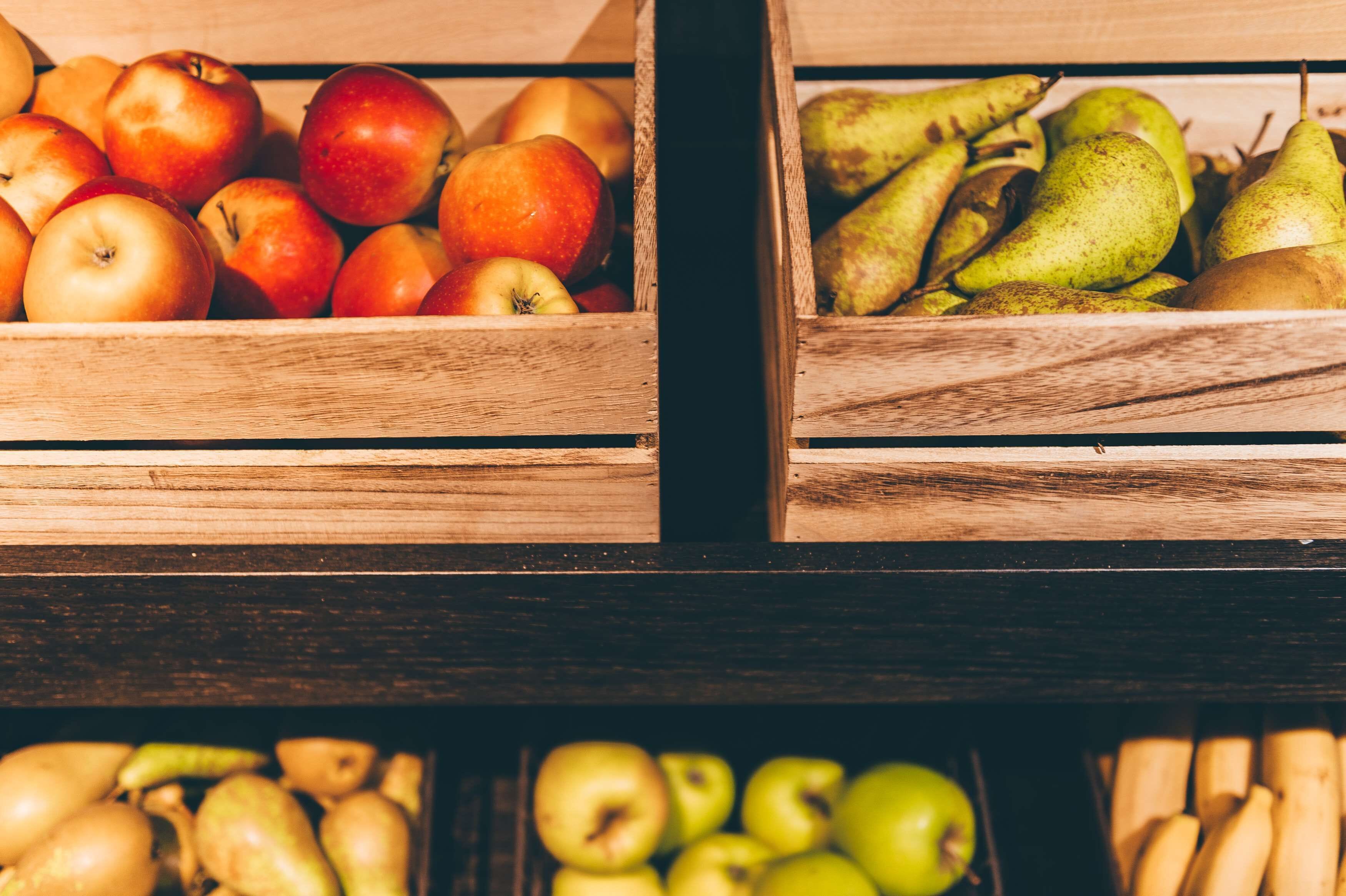Wooden crates filled with apples and pears.