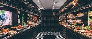 A narrow corridor with checkered flooring leading to a darkened area, flanked by shelves stocked with various food items and kitchenware. - Radisson Blu Plaza Hotel, Helsinki (Helsinki)
