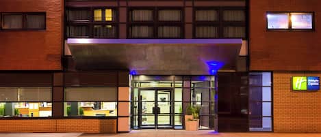 A Holiday Inn Express hotel with a brick facade, large windows, and a modern entrance.