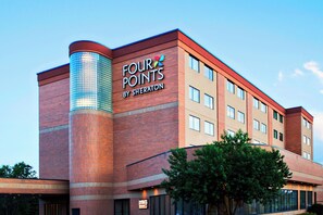 A hotel with a prominent 'FOUR POINTS BY SHERATON' sign on the side.