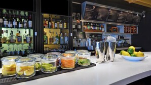 A bar area with shelves of liquor bottles, a menu board, and a bowl of lemons. - Courtyard by Marriott Shreveport Airport (Shreveport)
