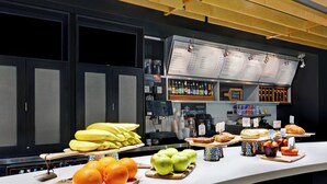 A breakfast bar with a coffee machine, fruit, pastries, and a menu. - Courtyard by Marriott Shreveport Airport (Shreveport)