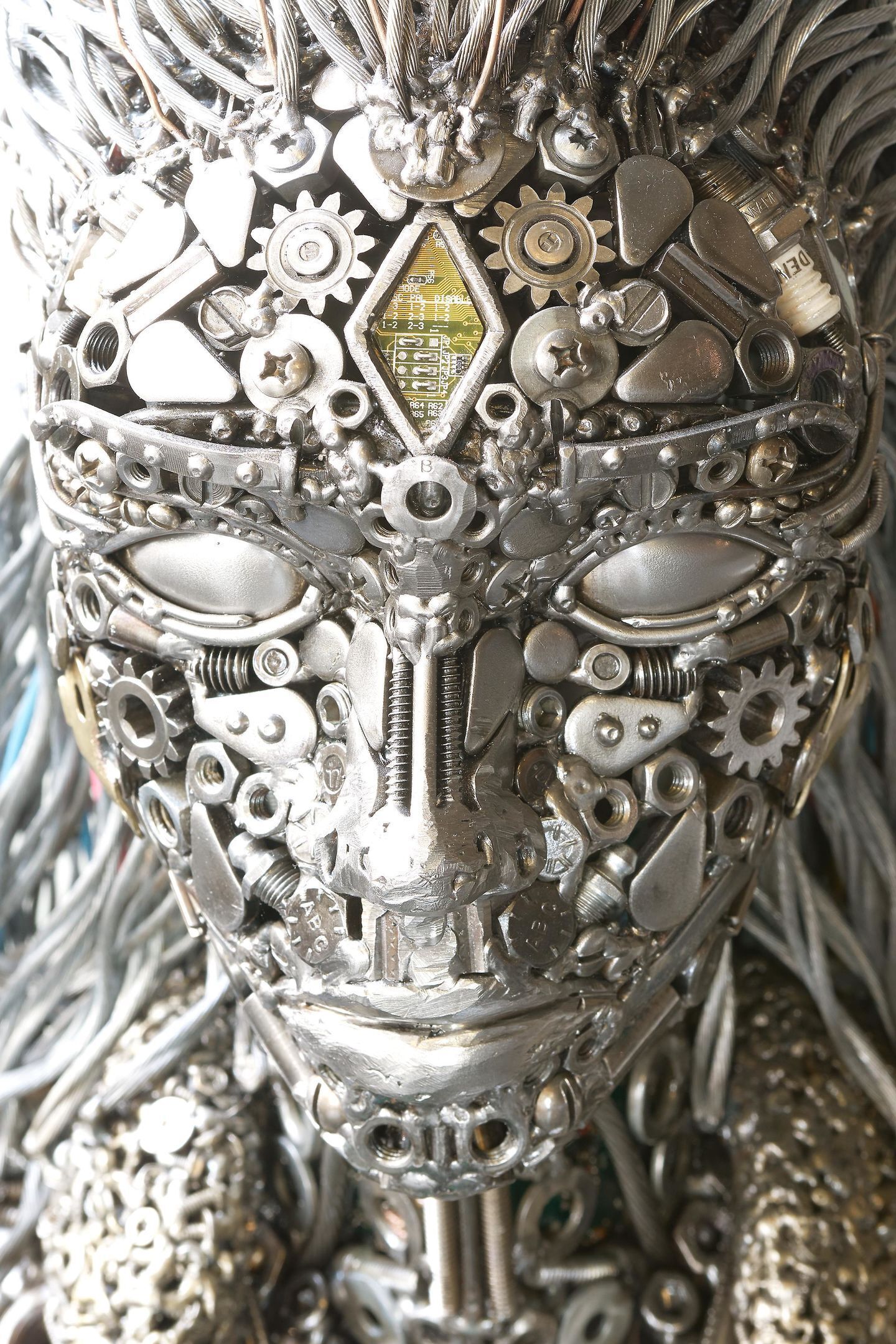 A close-up of a mechanical sculpture with gears and metallic elements.