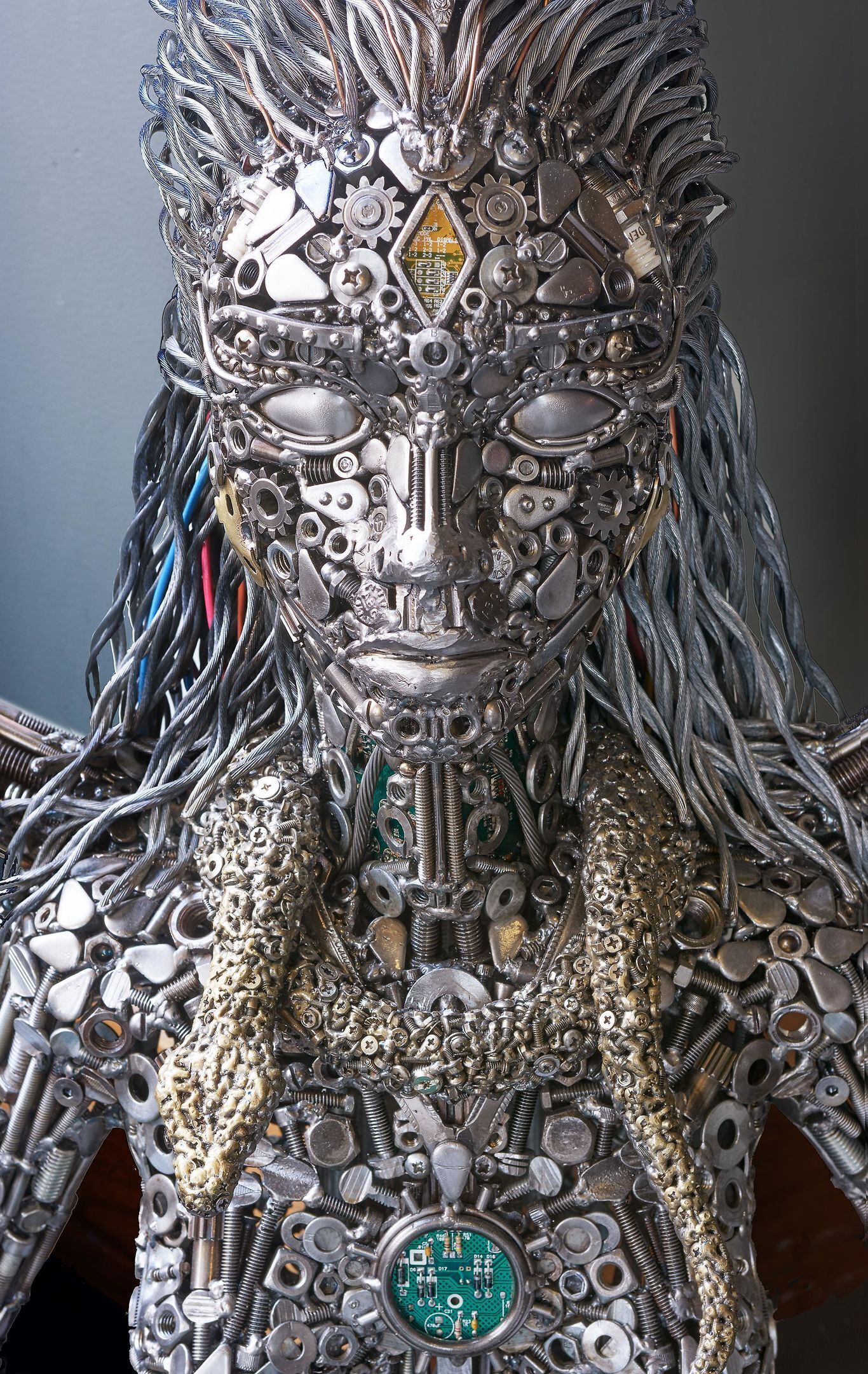 Une sculpture composée de différentes pièces mécaniques et de fils électriques.