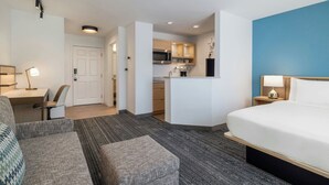 A hotel room with a bed, a desk, a chair, a kitchenette, and a bathroom. - TownePlace Suites by Marriott Gaithersburg (Gaithersburg)