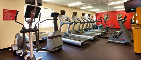A fitness center with treadmills, ellipticals, and a stationary bike.